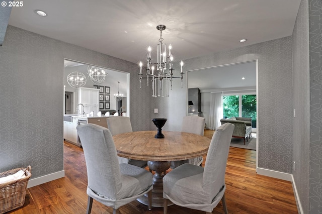 7100 SW Willowmere Dr, Portland, OR 97225 - dining area with a chandelier, wood finished floors, baseboards, wallpapered walls, and recessed lighting