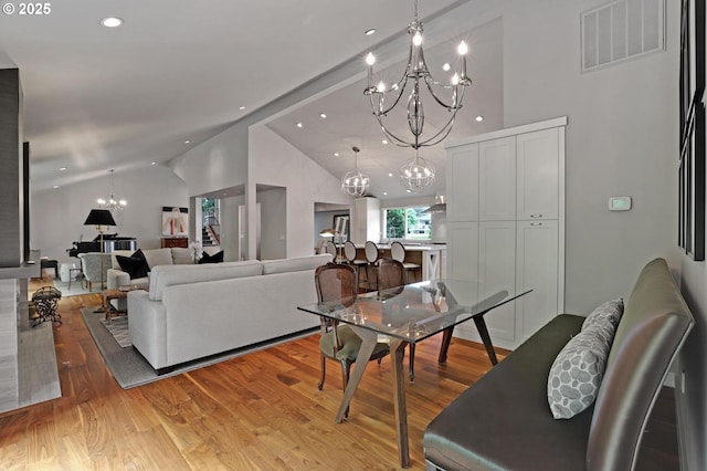7100 SW Willowmere Dr, Portland, OR 97225 - living room featuring a chandelier, light wood finished floors, high vaulted ceiling, and recessed lighting