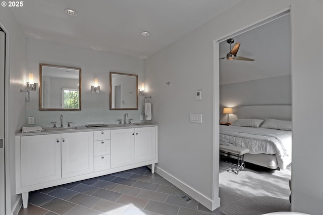 7100 SW Willowmere Dr, Portland, OR 97225 - full bathroom with double vanity, a ceiling fan, tile patterned floors, ensuite bath, and baseboards