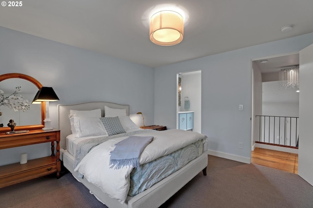 7100 SW Willowmere Dr, Portland, OR 97225 - carpeted bedroom featuring ensuite bath and baseboards