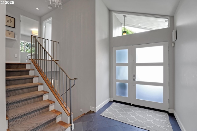 7100 SW Willowmere Dr, Portland, OR 97225 - foyer entrance with stairs, baseboards, tile patterned flooring, recessed lighting, and a chandelier