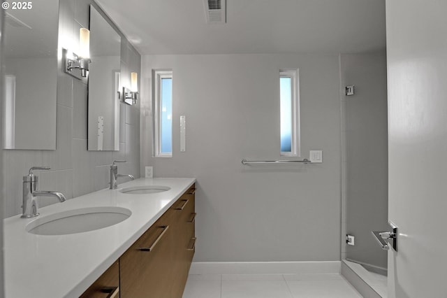 7100 SW Willowmere Dr, Portland, OR 97225 - full bath featuring plenty of natural light, double vanity, tile patterned floors, and baseboards