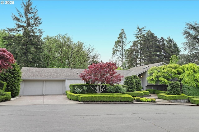 7100 SW Willowmere Dr, Portland, OR 97225 - view of front of property featuring concrete driveway and an attached garage