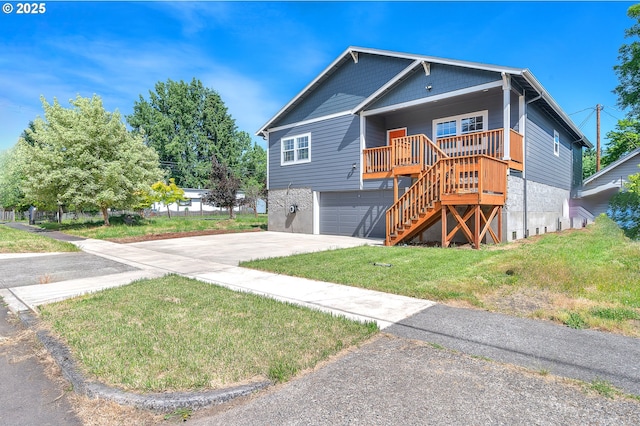 view of front facade with a garage, a front lawn, and covered porch