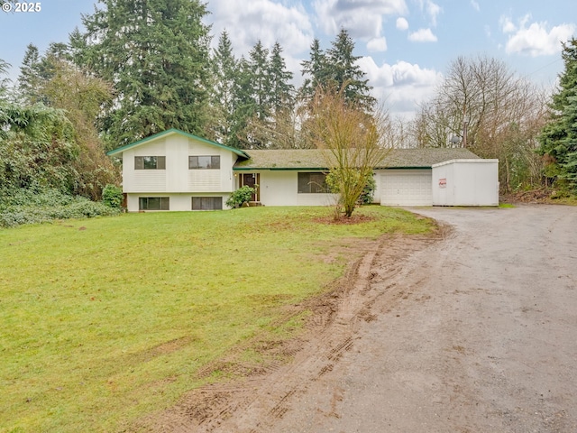 split level home with a front yard and a garage