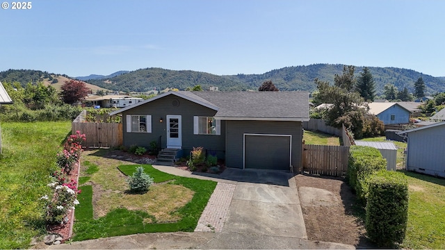 715 Penny Ln, Riddle, OR 97469 - view of front of property with a mountain view, a garage, concrete driveway, and a gate