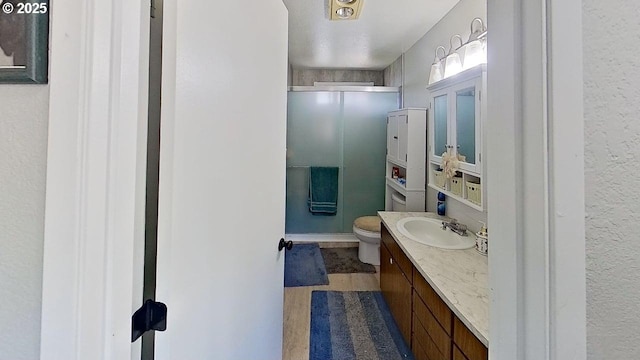 715 Penny Ln, Riddle, OR 97469 - bathroom with toilet, vanity, and wood finished floors