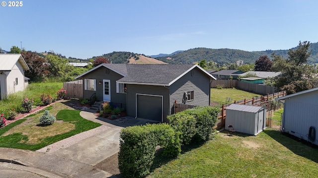 715 Penny Ln, Riddle, OR 97469 - view of front facade featuring a garage, driveway, a mountain view, and roof with shingles