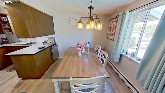 715 Penny Ln, Riddle, OR 97469 - dining room with plenty of natural light, light wood-style floors, a chandelier, and a textured ceiling