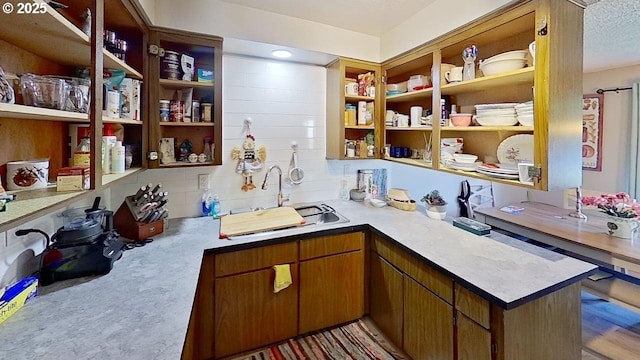 715 Penny Ln, Riddle, OR 97469 - kitchen with a sink, open shelves, light countertops, backsplash, and brown cabinetry