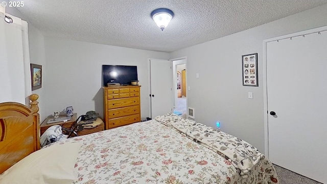 715 Penny Ln, Riddle, OR 97469 - carpeted bedroom featuring a textured ceiling