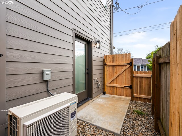 7040 N Leonard Ave, Portland, OR 97203 - view of patio / terrace with a cooling unit and a gate