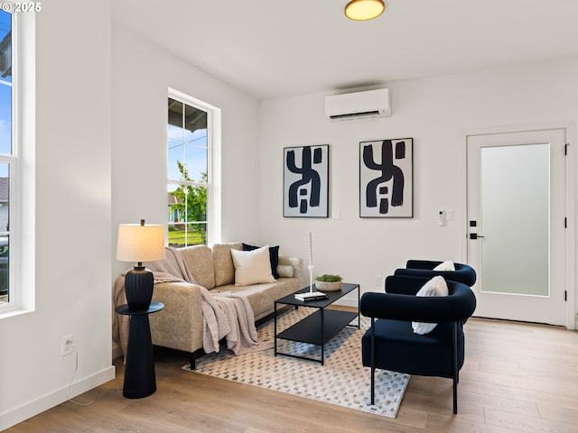 7040 N Leonard Ave, Portland, OR 97203 - living area featuring a wall mounted air conditioner, wood finished floors, and baseboards