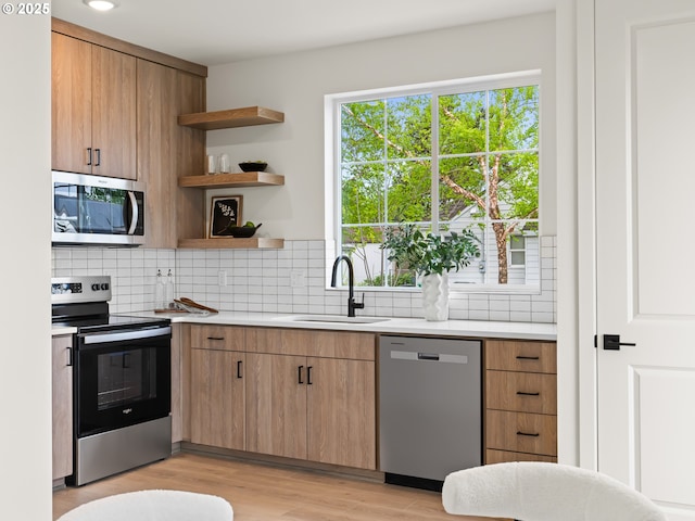 7040 N Leonard Ave, Portland, OR 97203 - kitchen featuring appliances with stainless steel finishes, a sink, light countertops, tasteful backsplash, and recessed lighting