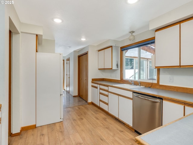 kitchen featuring a sink, white cabinetry, light wood-type flooring, freestanding refrigerator, and dishwasher