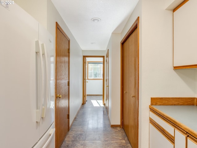 corridor featuring baseboards