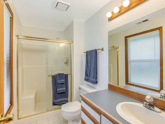 bathroom featuring toilet, a stall shower, visible vents, and vanity