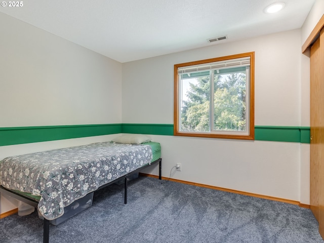 carpeted bedroom with baseboards and visible vents