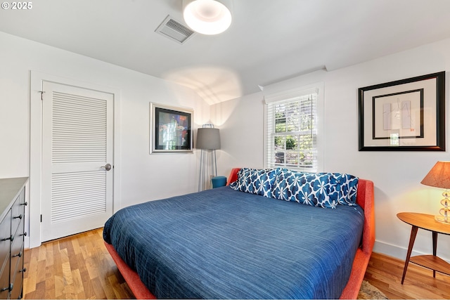 bedroom featuring wood finished floors, vaulted ceiling, and baseboards