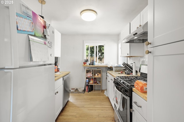 1510 W 10th St, The Dalles, OR 97058 - kitchen featuring stainless steel appliances, under cabinet range hood, light wood finished floors, white cabinets, and light countertops