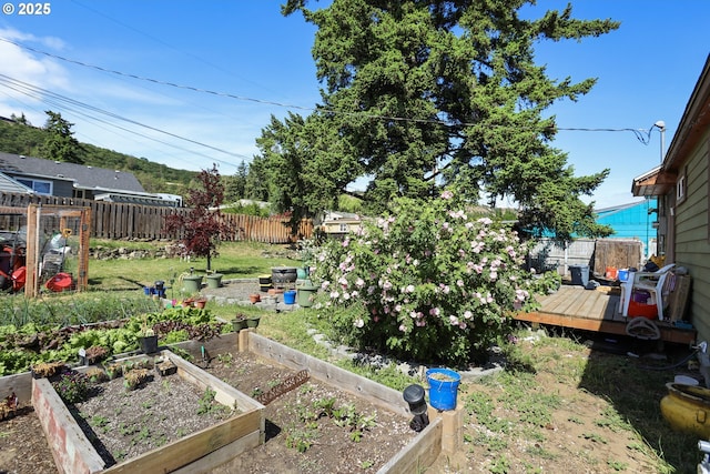 1510 W 10th St, The Dalles, OR 97058 - fenced backyard featuring a garden and a wooden deck