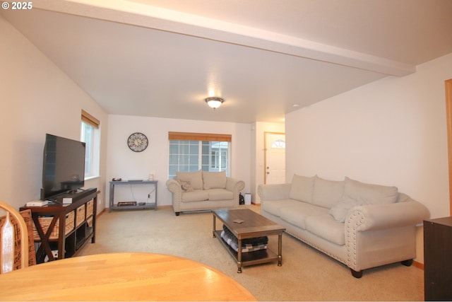 living room with light carpet, a wealth of natural light, and beam ceiling