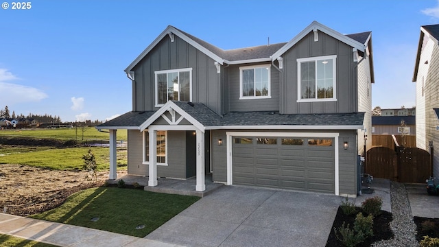 view of front of property featuring board and batten siding, concrete driveway, and an attached garage