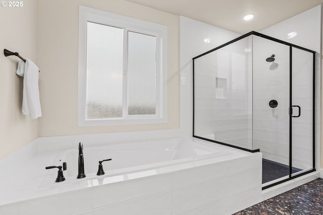 bathroom with a stall shower, a garden tub, and recessed lighting