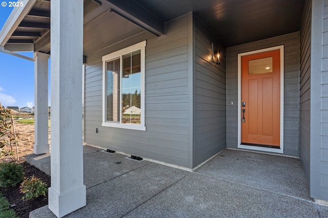 doorway to property featuring covered porch