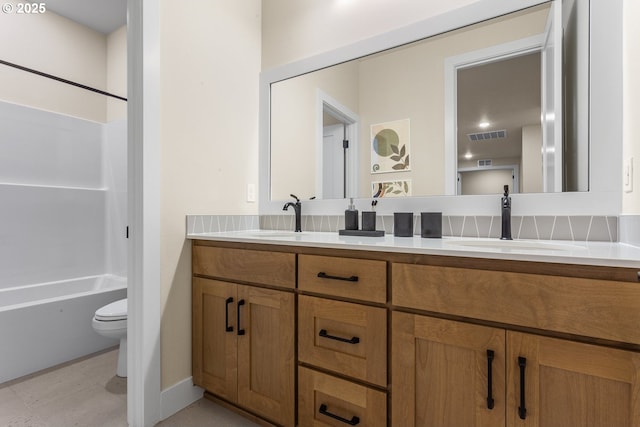 full bath with double vanity, shower / tub combination, a sink, and toilet