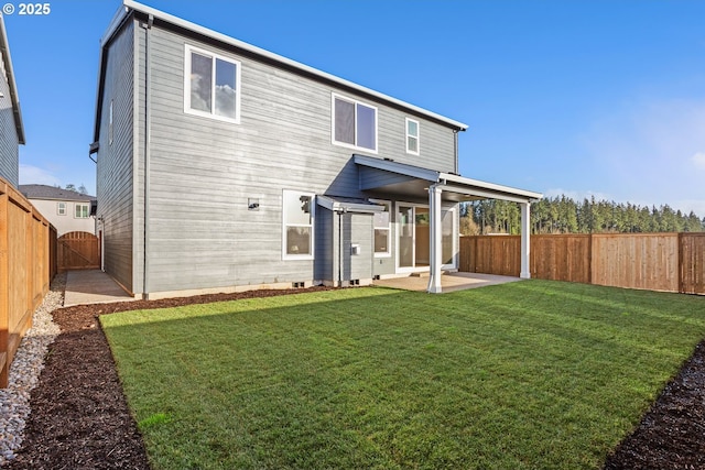 back of property featuring a patio, a lawn, a fenced backyard, and a gate