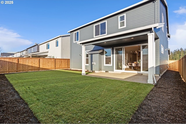 back of house featuring a patio, a yard, and a fenced backyard