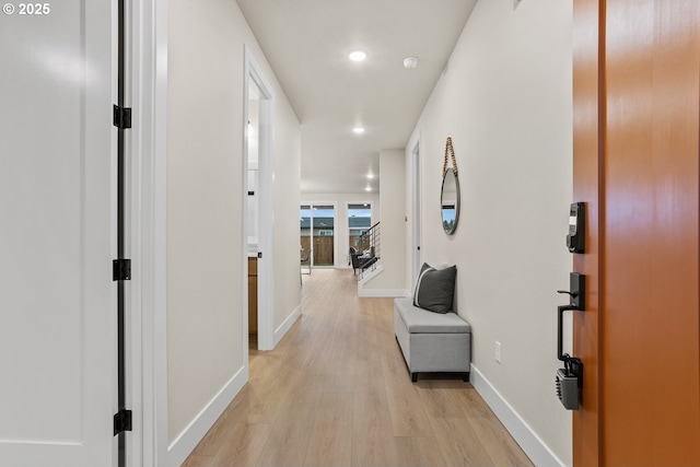 corridor with recessed lighting, baseboards, and light wood finished floors