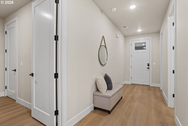 hall featuring recessed lighting, baseboards, visible vents, and light wood finished floors