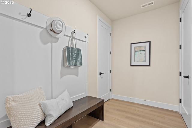 mudroom with baseboards, visible vents, and light wood-style floors