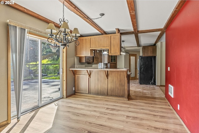 151 Owl Creek Rd, Kelso, WA 98626 - kitchen featuring a peninsula, stainless steel appliances, a notable chandelier, visible vents, and beamed ceiling