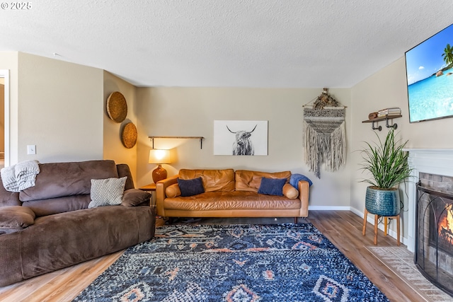 13503 NE 80th Cir, Vancouver, WA 98682 - living room featuring a tile fireplace, wood finished floors, and a textured ceiling