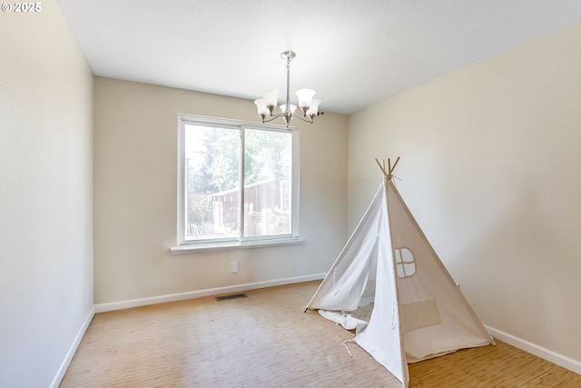 13503 NE 80th Cir, Vancouver, WA 98682 - recreation room with a chandelier and wood finished floors