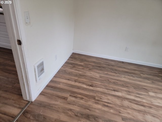 interior details with electric panel, visible vents, and wood finished floors