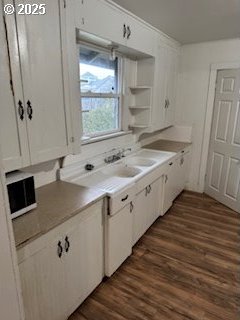 washroom featuring laundry area, washing machine and dryer, baseboards, and wood finished floors