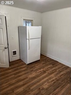 clothes washing area with dark wood-style floors, visible vents, electric dryer hookup, laundry area, and baseboards