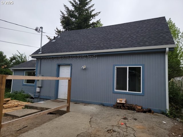 exterior space with roof with shingles