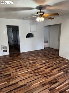 spare room featuring a ceiling fan and dark wood-style flooring