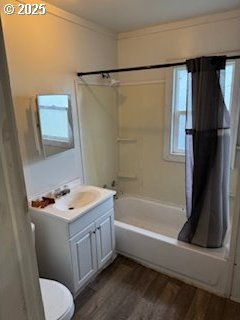 bathroom with toilet, ornamental molding, shower / tub combo, vanity, and wood finished floors