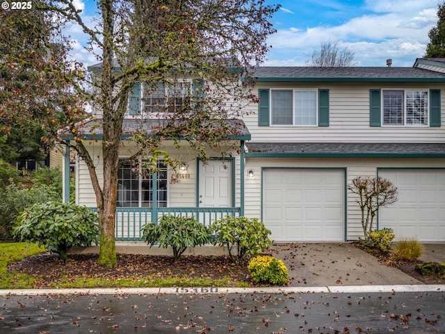 multi unit property featuring a shingled roof, covered porch, an attached garage, and concrete driveway