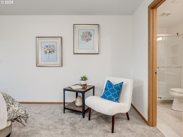 sitting room featuring light colored carpet, baseboards, and visible vents