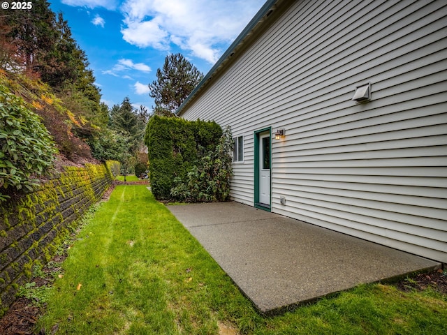 view of property exterior with a patio, fence, and a yard