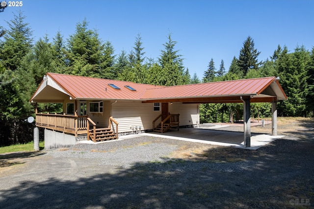 25363 Wonderly Rd, Rainier, OR 97048 - view of front of home with metal roof, an attached carport, and gravel driveway