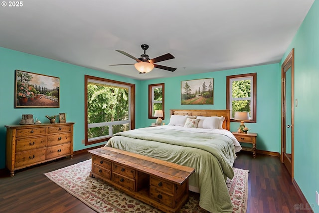 25363 Wonderly Rd, Rainier, OR 97048 - bedroom with multiple windows, dark wood-style floors, and baseboards