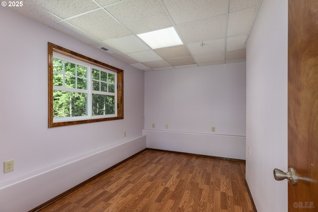 25363 Wonderly Rd, Rainier, OR 97048 - empty room with wood finished floors and a drop ceiling